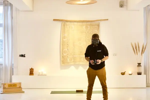 A person on a mat mid-practice in a bright room, focused and at ease